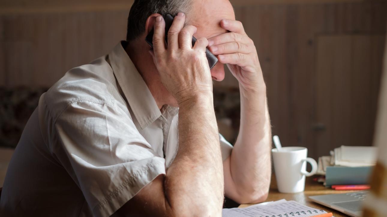 Homme découragé parlant au téléphone