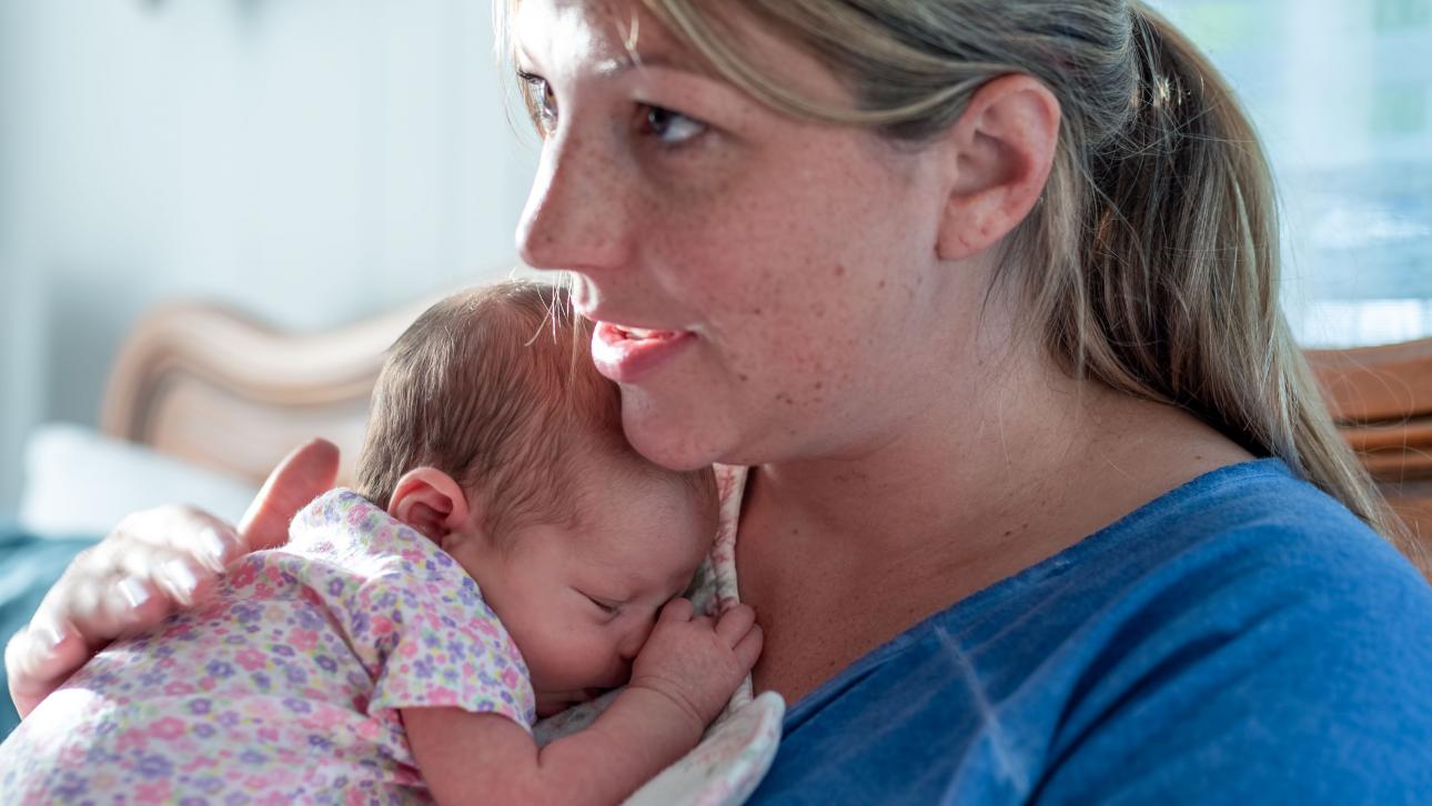 DPJ worker holding a baby in her arms