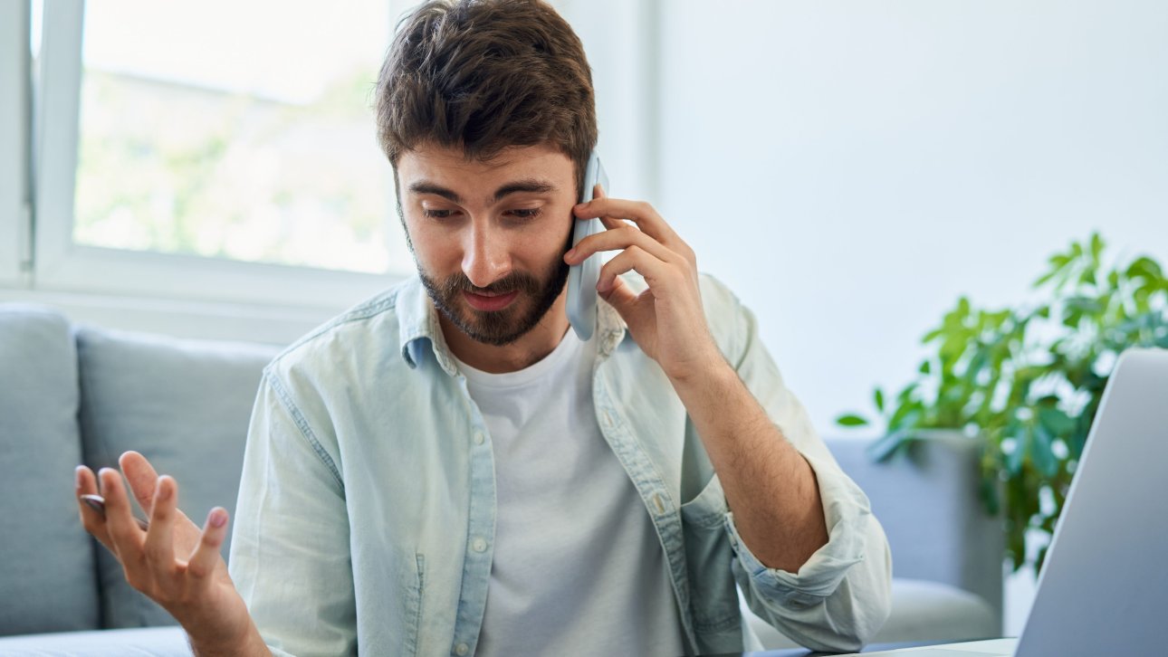 Confused citizen looking at his papers while talking on the phone