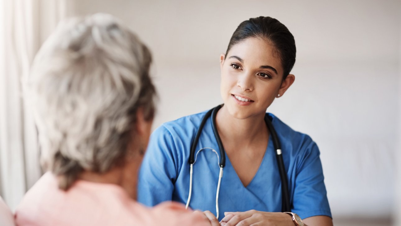 A specialist nurse practitioner is talking to a patient.