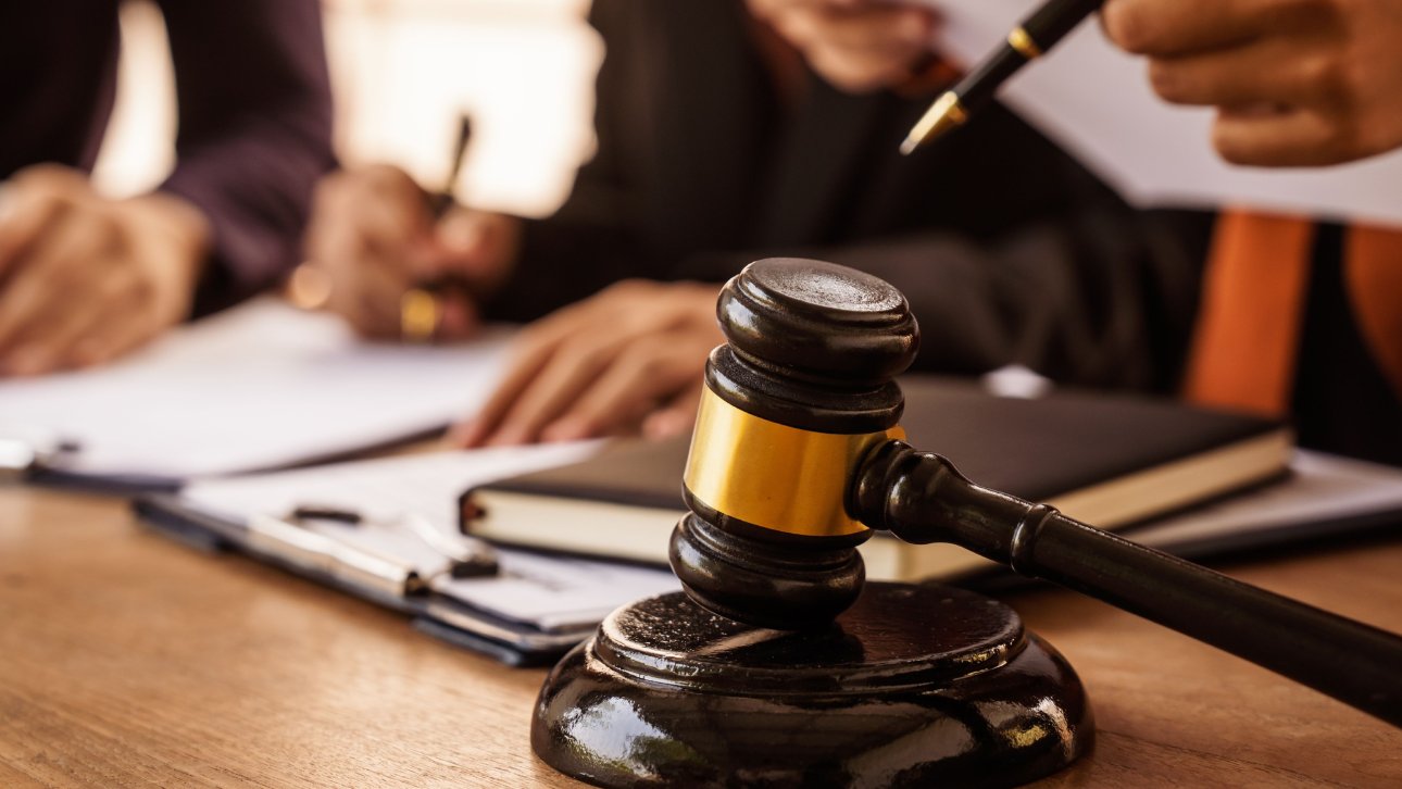 Lawyers at work, with the gavel of justice visible in the foreground.